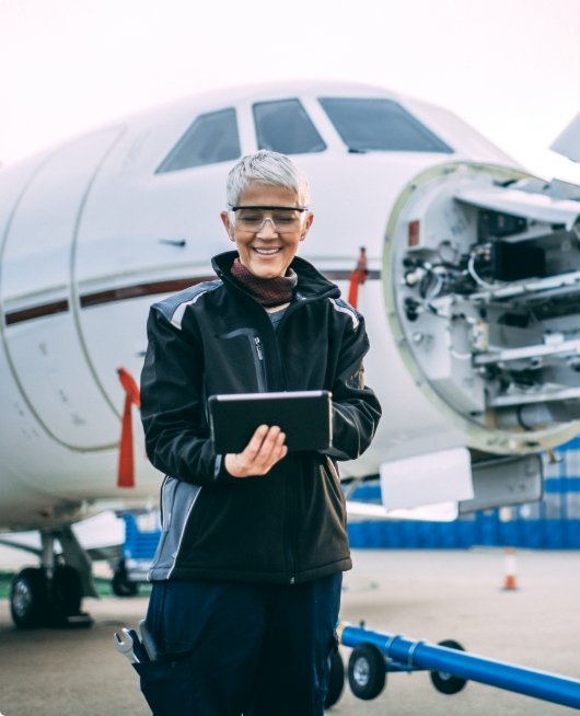Close-up of a female engineer checking off the requirements for a plan behind her